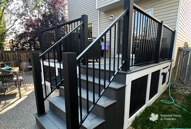 Trex Clam Shell deck with PVC lattice skirting and custom 4"x4" post railings.